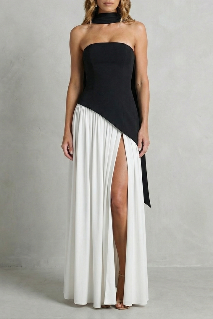 Black strapless formal gown with asymmetric drape and pleated skirt with high slit