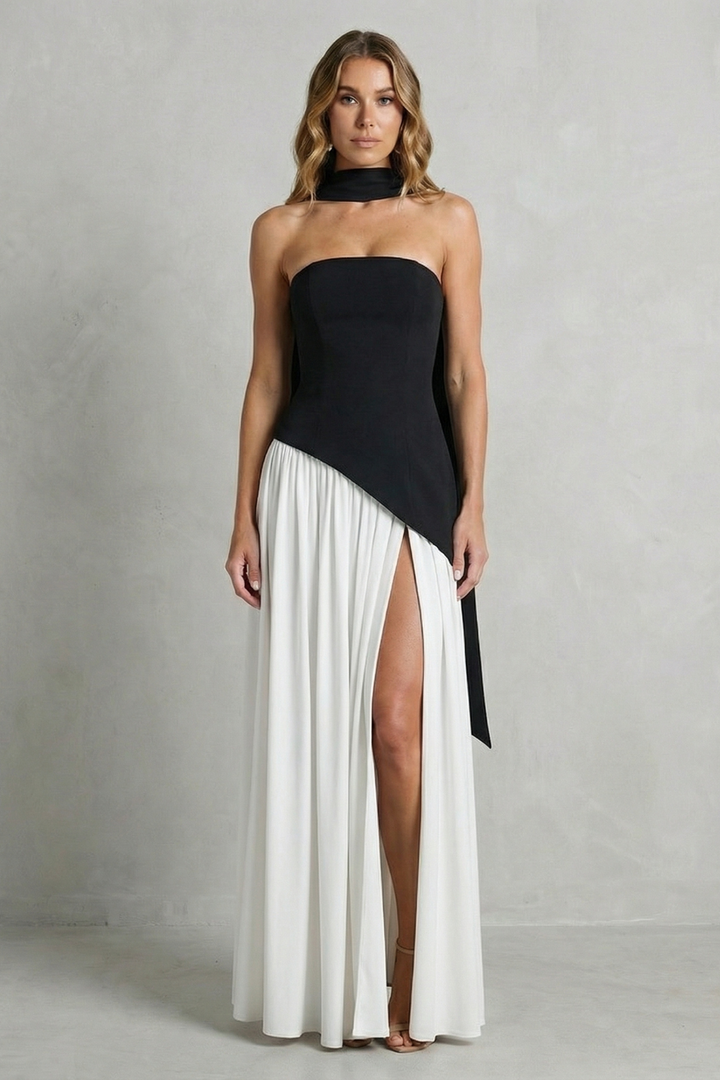 Black strapless formal gown with draped bodice and pleated skirt with leg slit