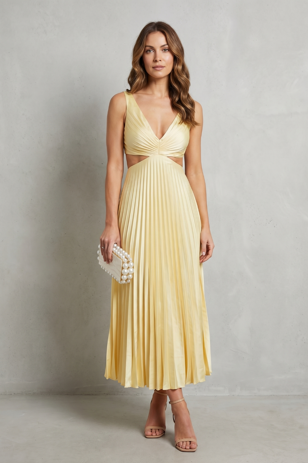 Yellow waist-pleated maxi dress with V-neck ruched bodice, sleeveless; pearl beaded clutch