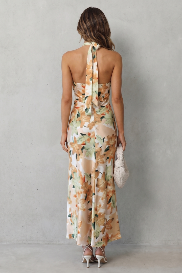 Floral halter maxi dress back view, champagne base with floral print and tied halter