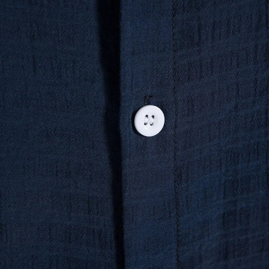 Navy shirt placket with round white button detail