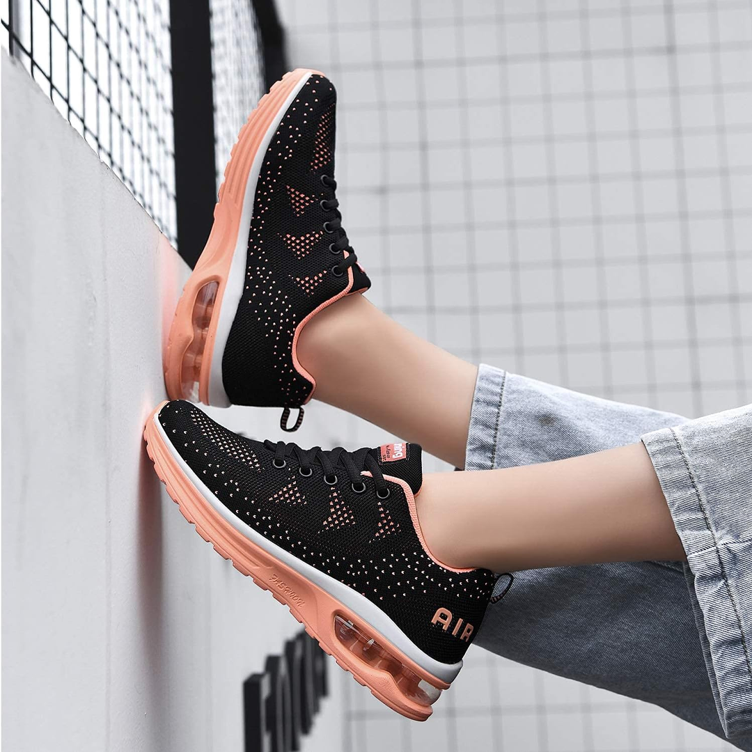 Black lace-up sneakers with orange mesh trim and air-cushion soles on legs