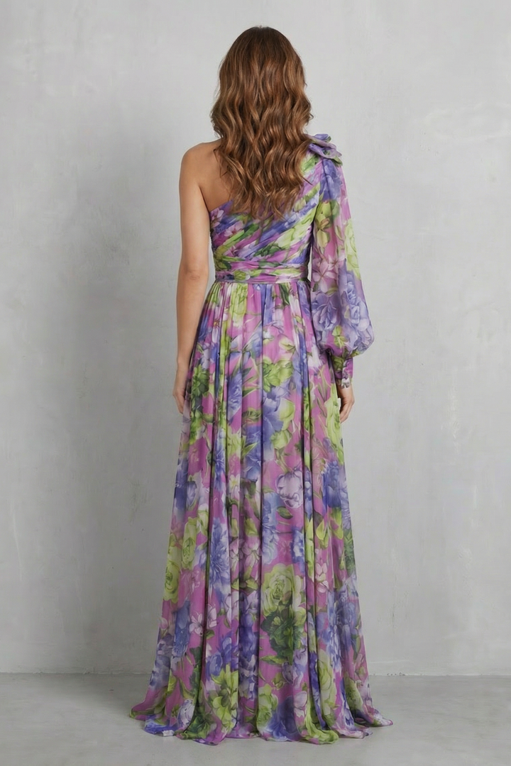 Women's one-shoulder floral maxi dress in purple, back view, pleated skirt with slit