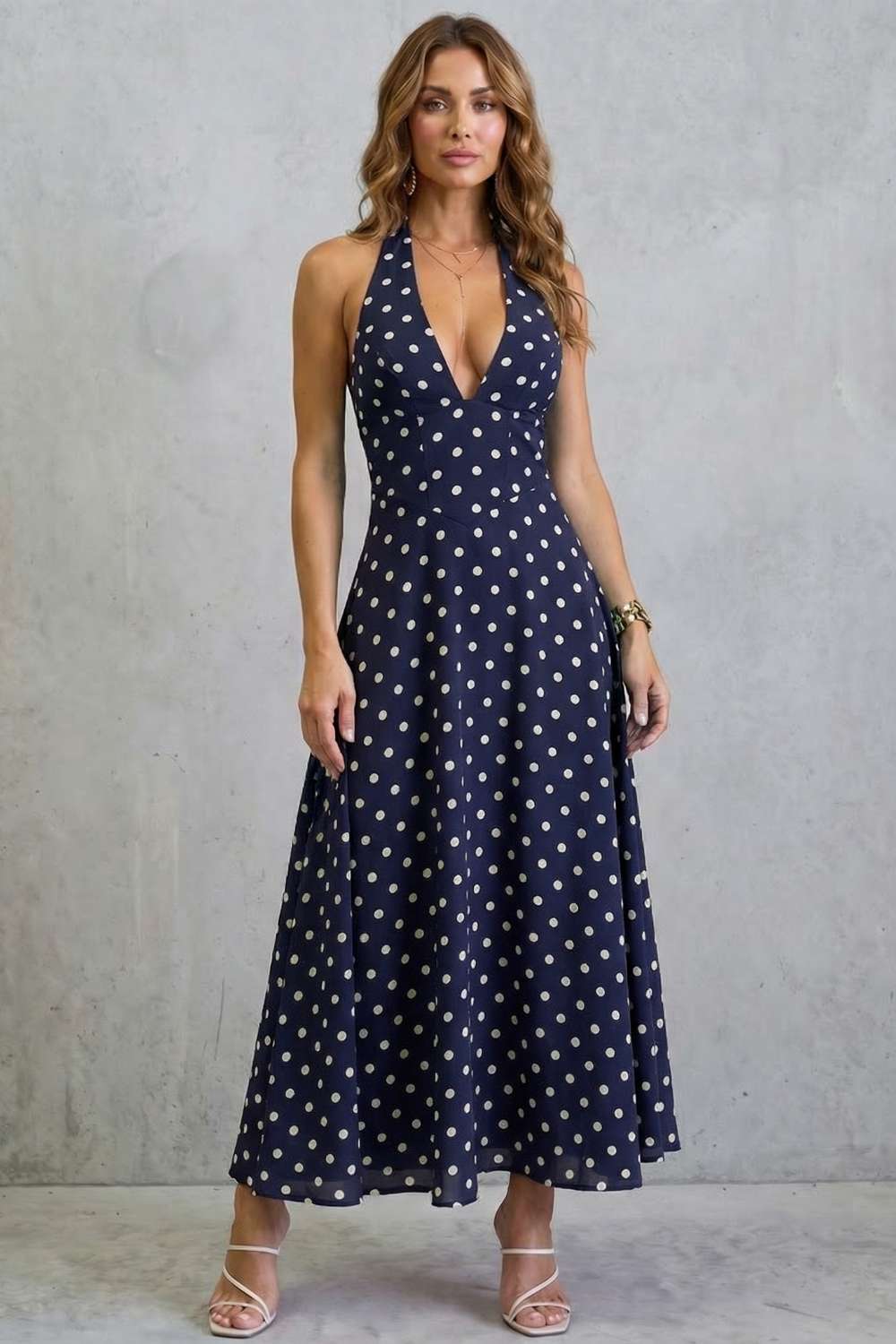 Navy halter-style maxi dress with deep V front and scattered white polka dots