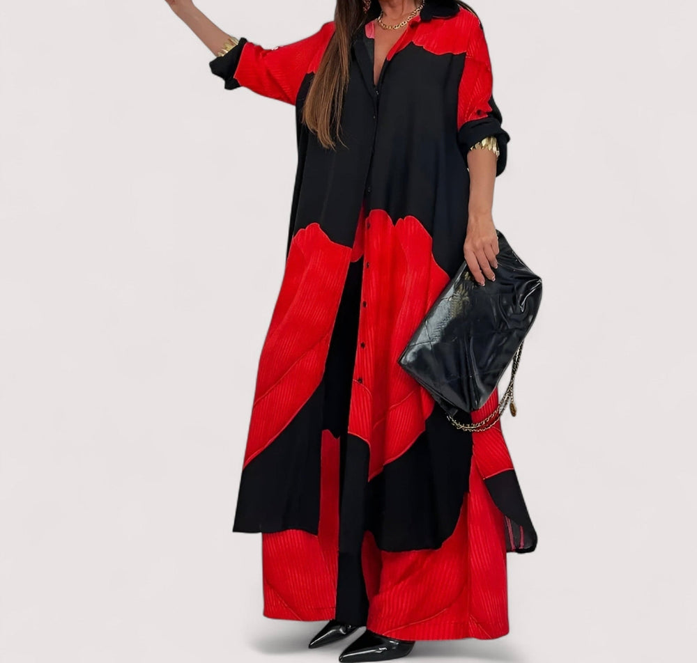 Red and black flowing two-piece set with long draped jacket and wide-leg pants