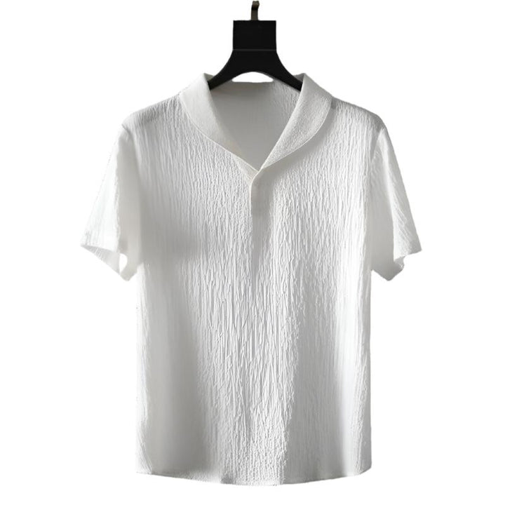 White cotton polo shirt with short sleeves and buttoned collar.