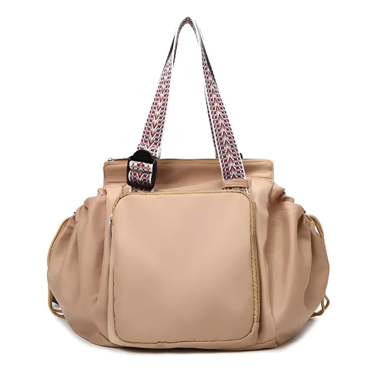 Tan 3-in-1 organized tote bag with front pocket, ruffled sides, and patterned shoulder straps