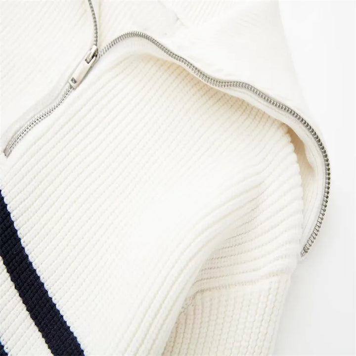 White ribbed knit quarter-zip sweater close-up of metal zipper and seam