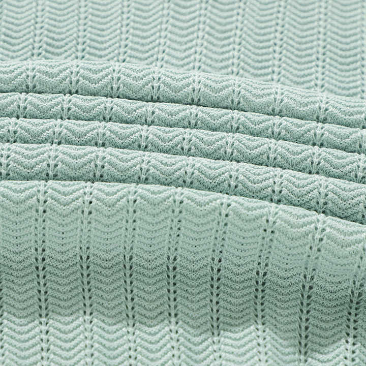 Mint knit fabric texture with repeating wave and zigzag stitch pattern