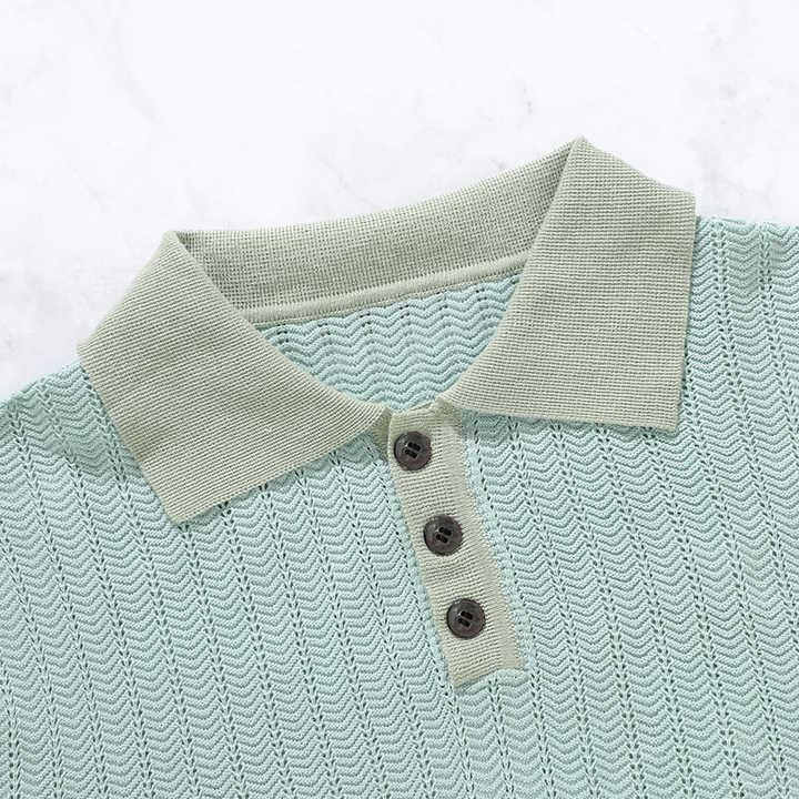 Mint knit polo close-up with pointed collar and dark button placket