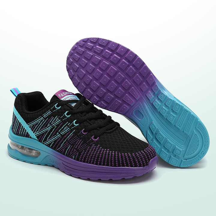 Walking sneakers pair, black knit with purple/teal pattern, purple tread sole, blue midsole