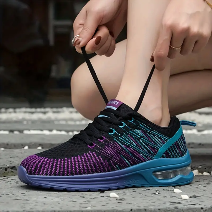 Lace-up walking sneaker, black upper with purple and teal knit stripes, blue air sole