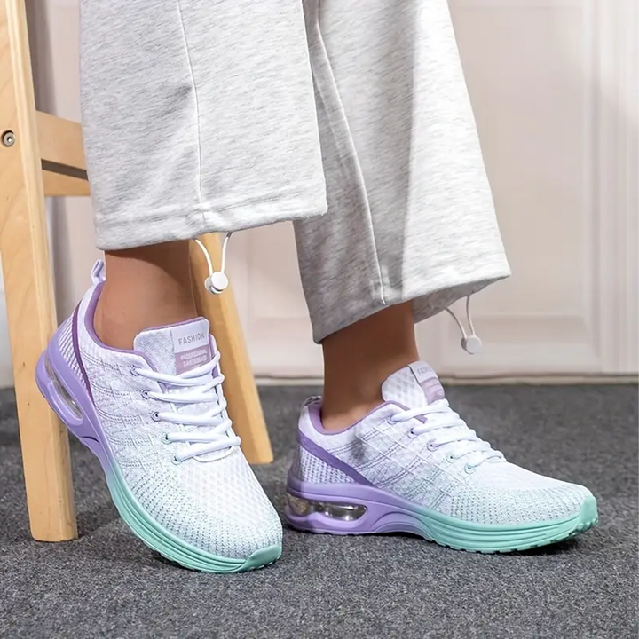 Women’s air cushion walking sneakers on feet: lavender upper, teal air sole