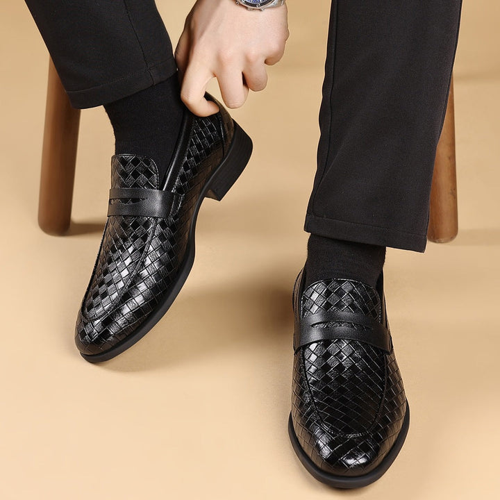 Black woven slip-on business shoes with cross strap, rounded toe, and low heel