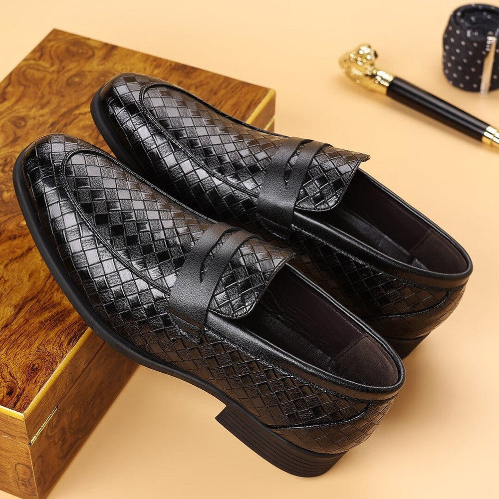 Black woven slip-on business shoes with crisscross strap detail and dark rubber soles