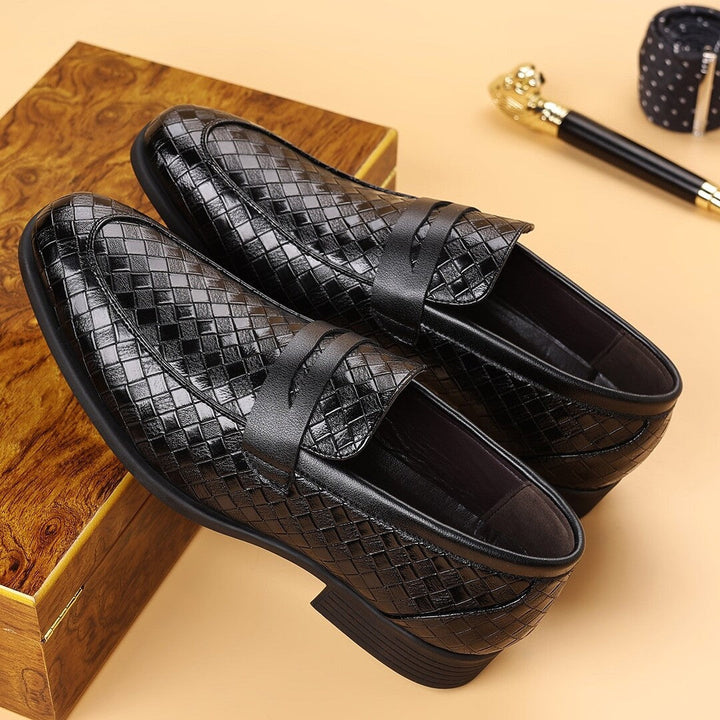 Black woven slip-on business shoes with crisscross strap detail and dark rubber soles