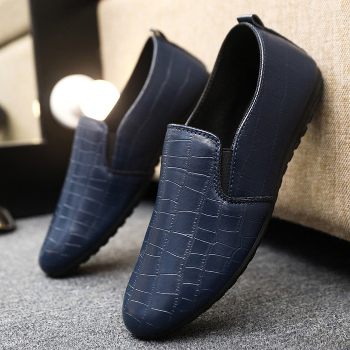 Blue croc-textured slip-on loafers with elastic side panels