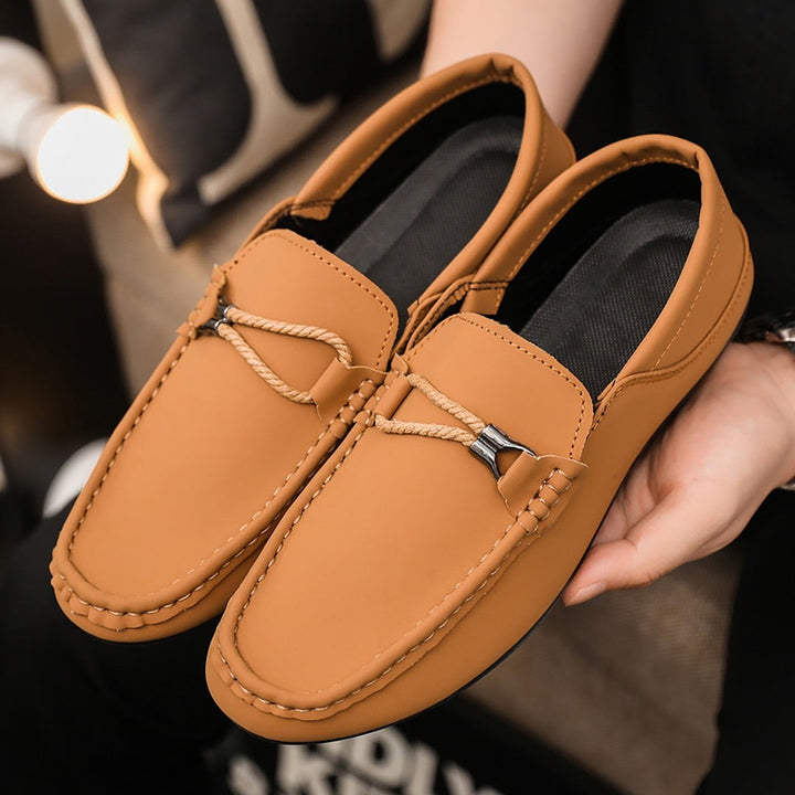 Brown casual loafers close-up with braided strap and metal buckle
