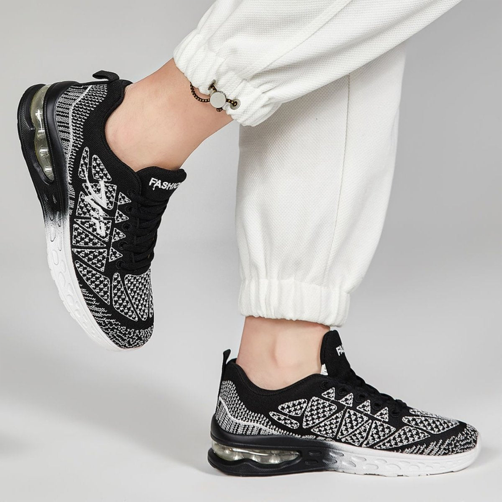 Black-and-white patterned lace-up walking sneakers with visible air-cushion sole
