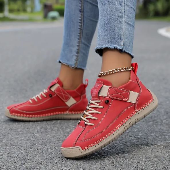 Red lace-up sneakers with white midsole and stitched side stripes