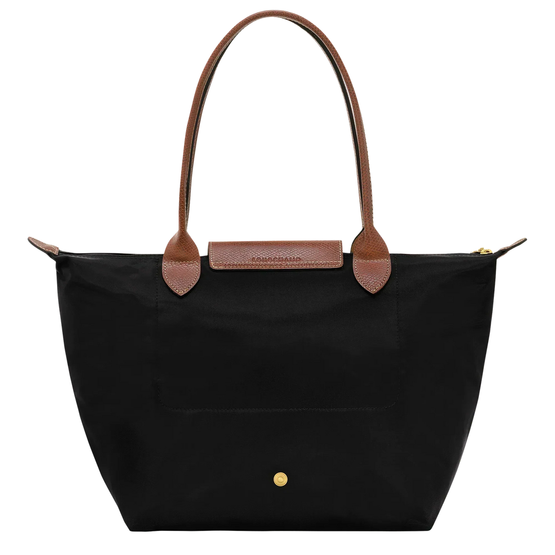 Longchamp medium tote in black with tan handles, front pocket and gold snap details