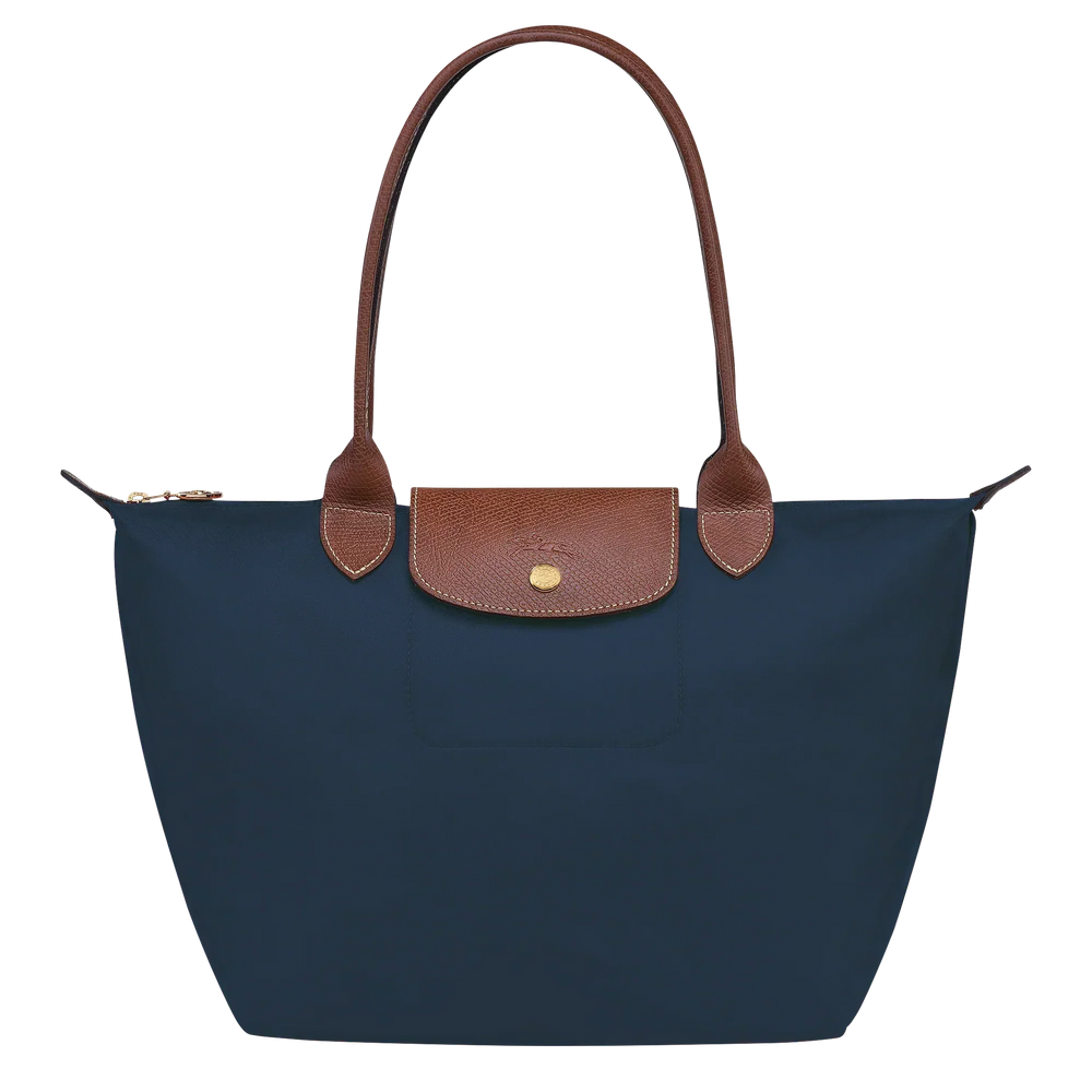 Medium Le Pliage tote with navy fabric, tan leather trim, and front snap pocket