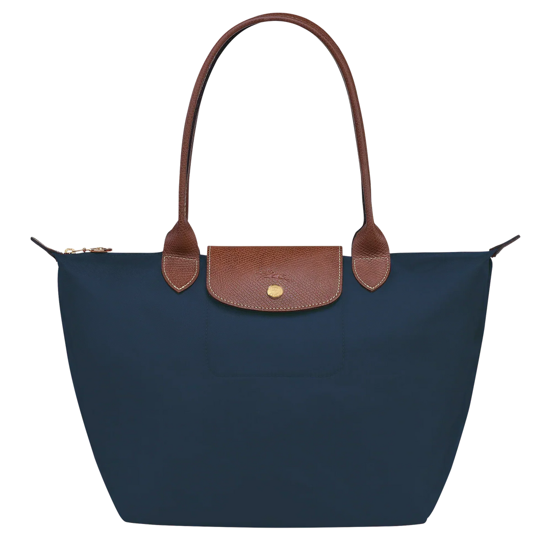 Medium Le Pliage tote with navy fabric, tan leather trim, and front snap pocket