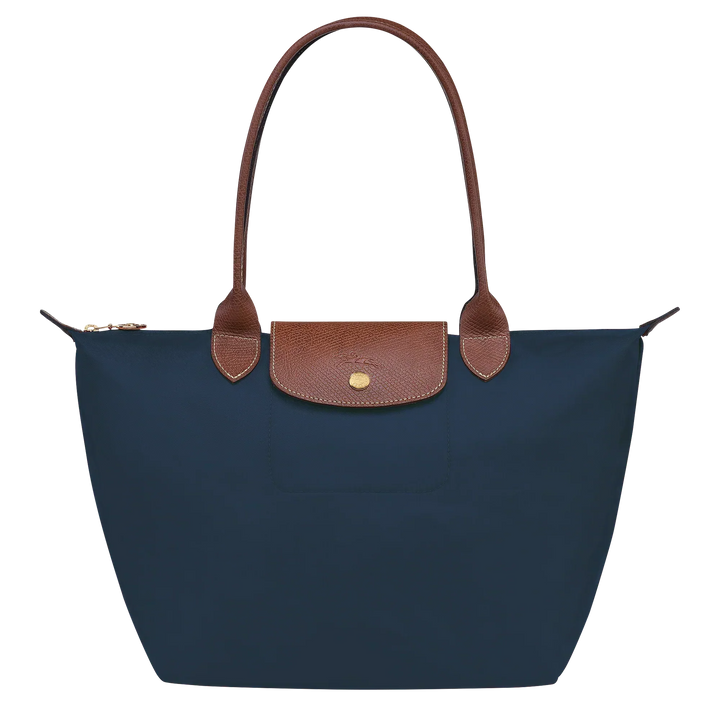 Medium Le Pliage tote with navy fabric, tan leather trim, and front snap pocket
