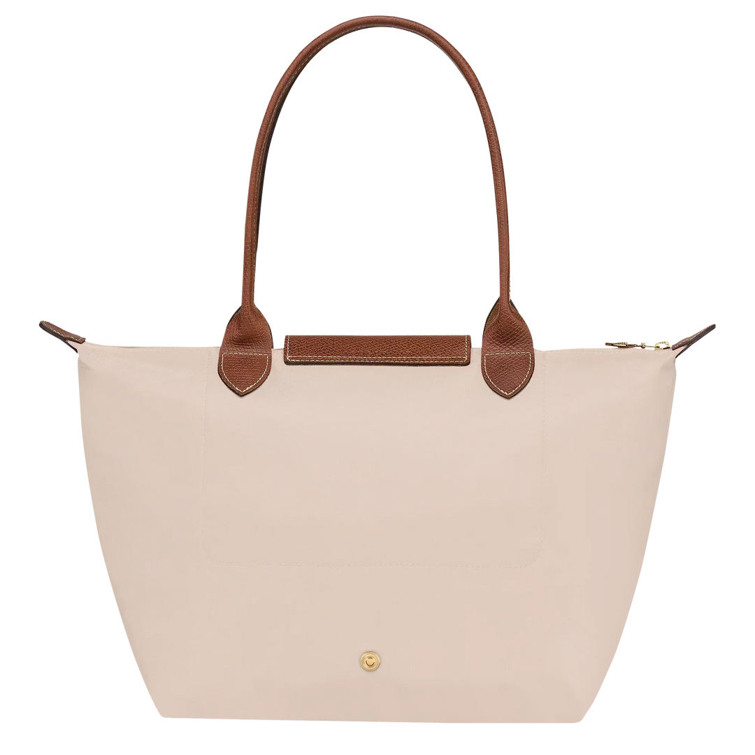 Medium Le Pliage tote front view in paper canvas with brown leather handle and gold button