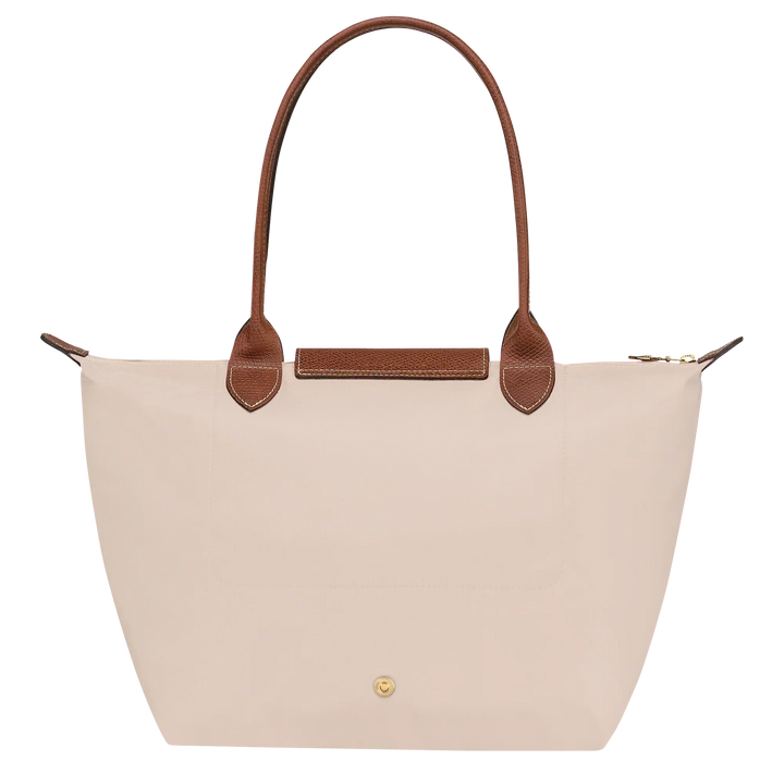 Medium Le Pliage tote front view in paper canvas with brown leather handle and gold button