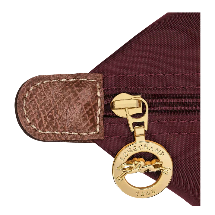 Longchamp Le Pliage clasp and zipper pull on burgundy fabric tote