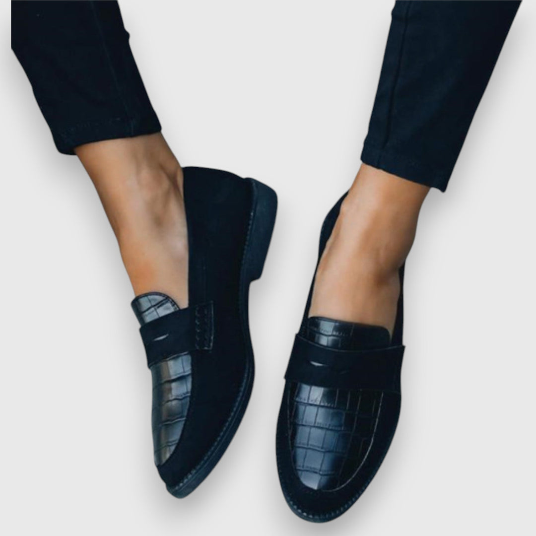Black cushioned penny loafers with croc-texture strap