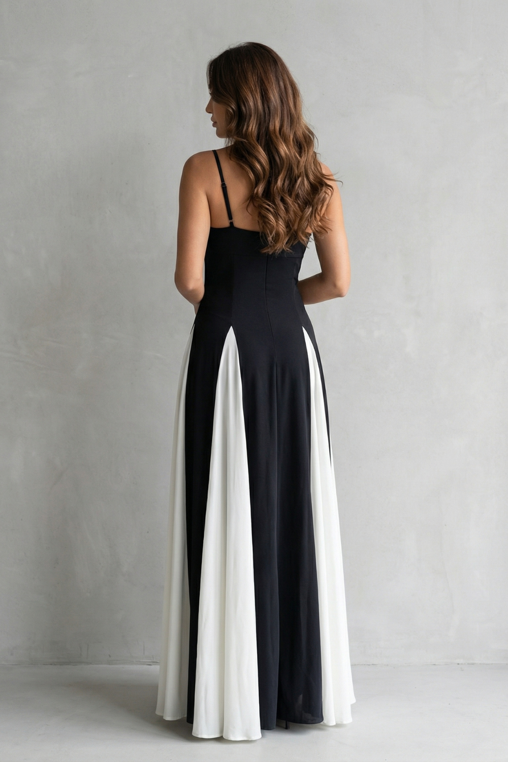 Contrast maxi dress back view with spaghetti straps; black and white contrast panel along hem