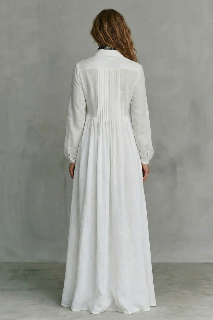 White mandarin-collar maxi dress with long sleeves and gathered back yoke