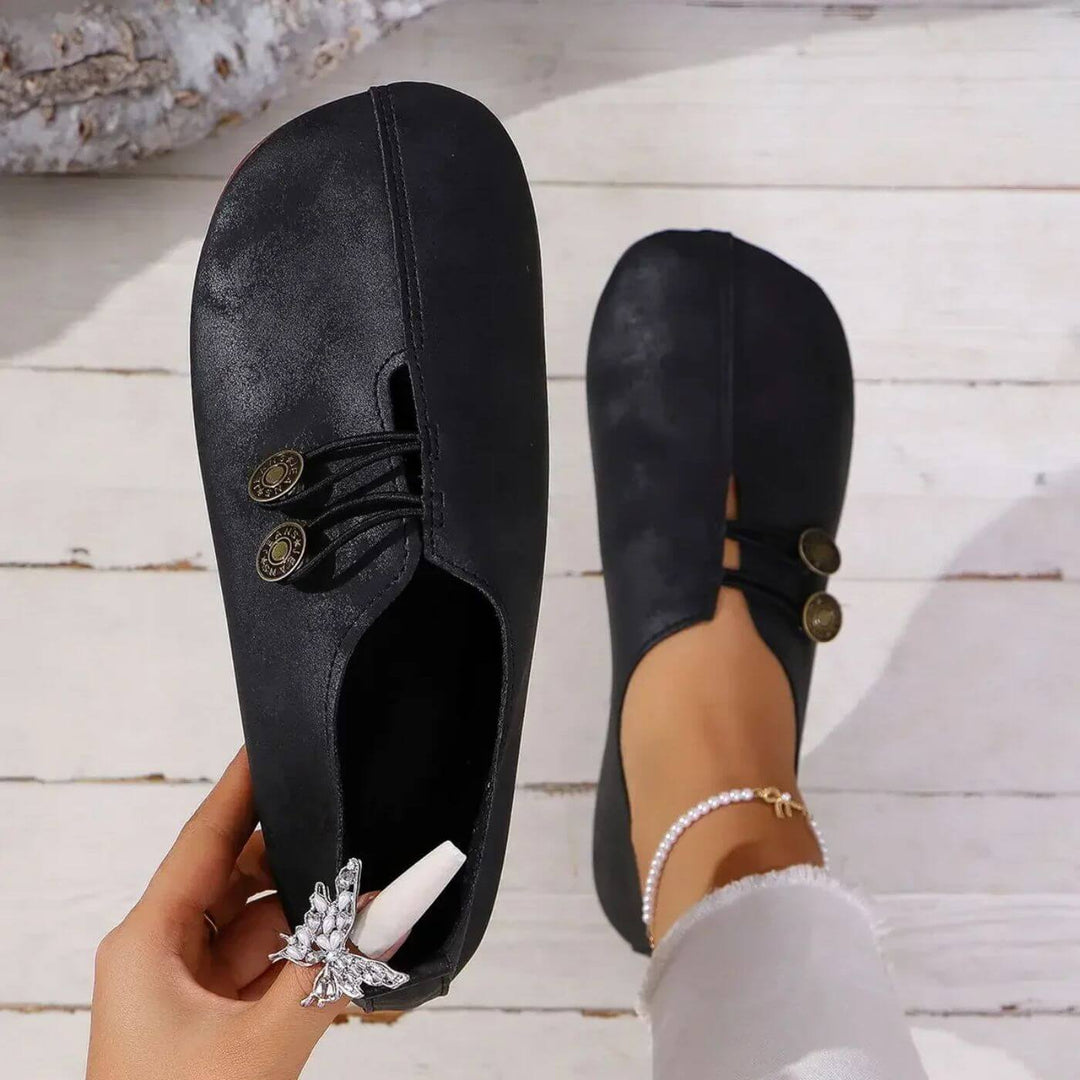 Black button slip-on flats with lace-up vamp and decorative button detail