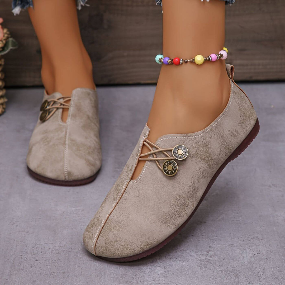 Beige suede-look button slip-on flats with lace tie and two button medallions