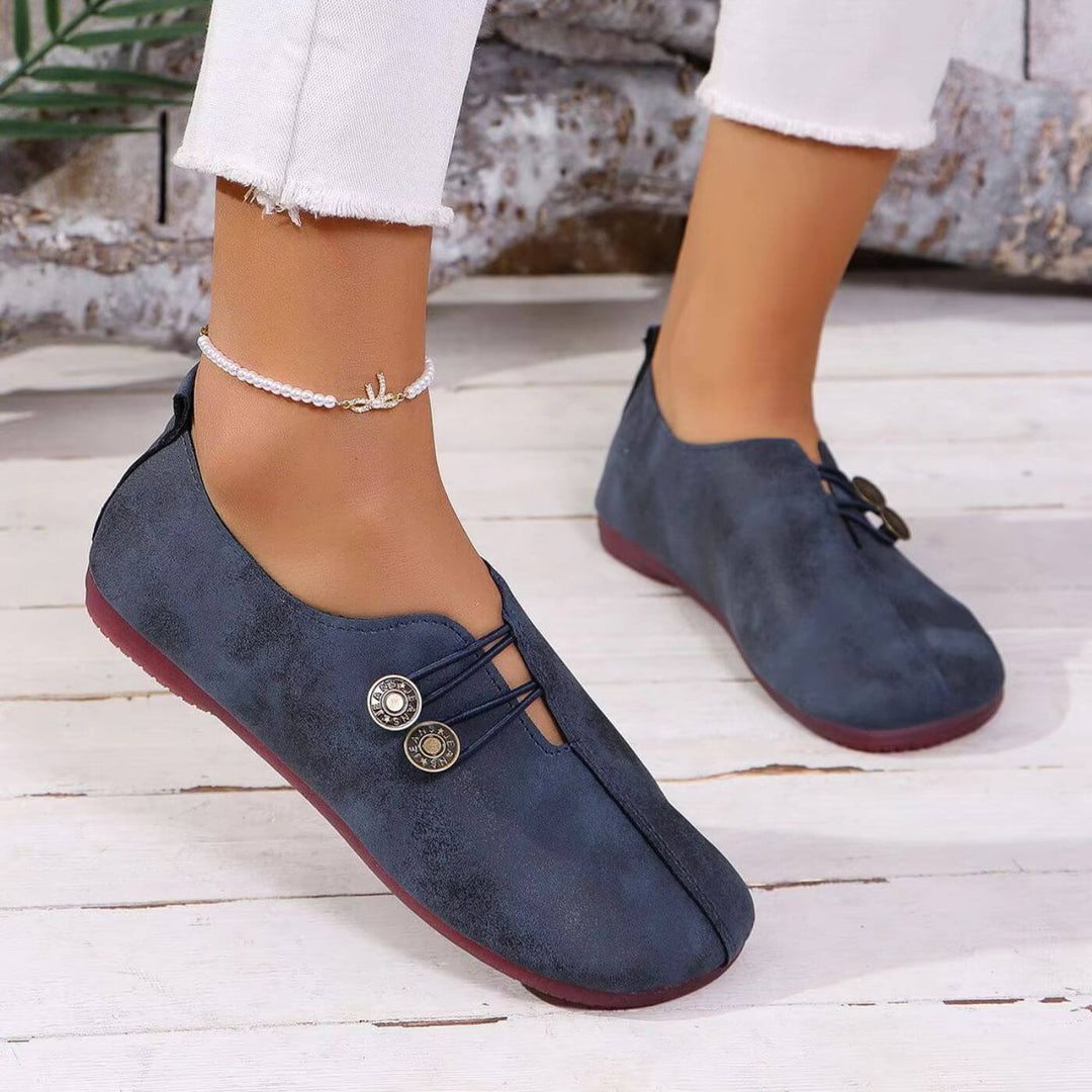 Navy blue button slip-on flats with lace-up vamp and round logo medallion