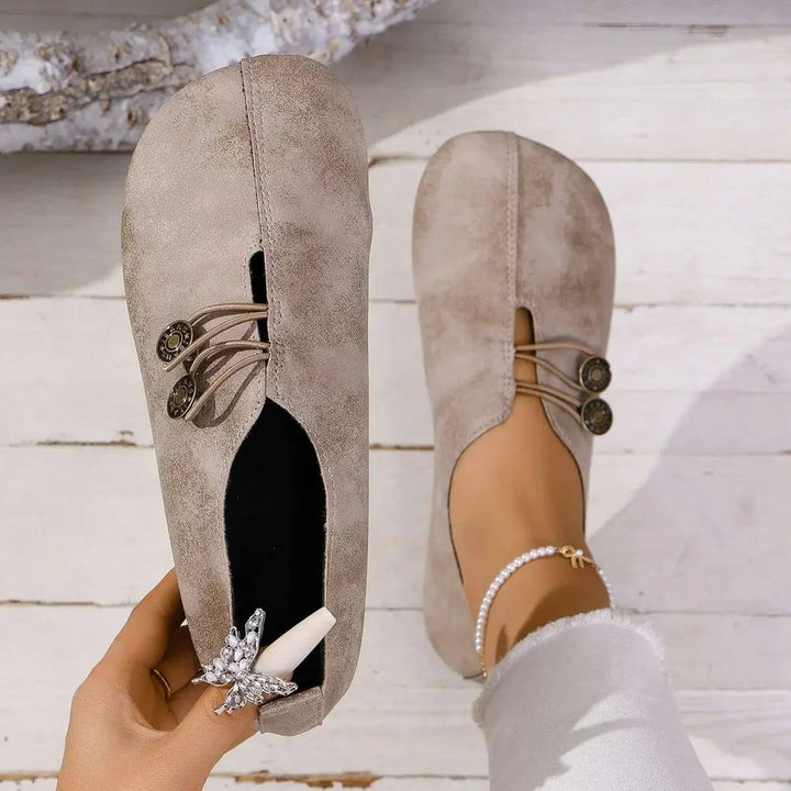 Light brown button slip-on flats with lace-up vamp and decorative button detail