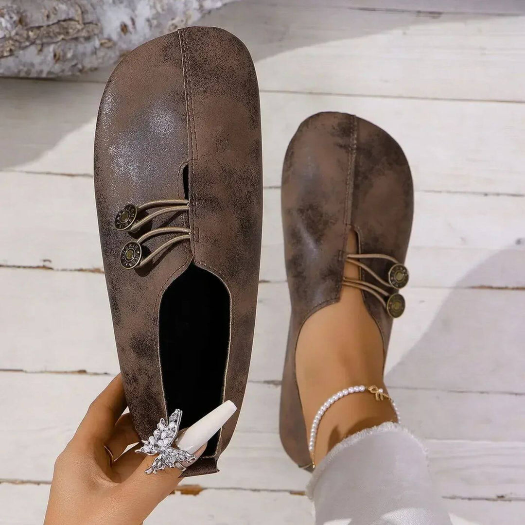 Dark brown button slip-on flats with lace-up vamp and decorative button detail