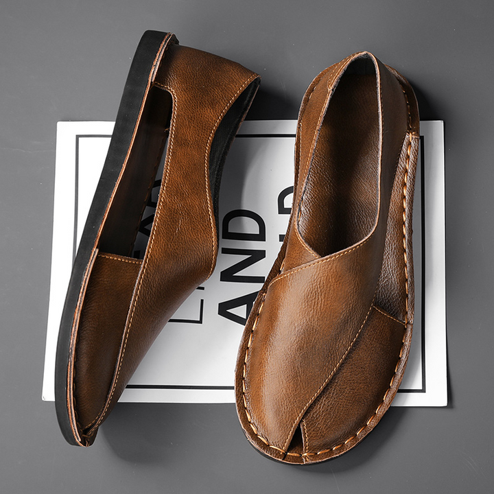 Brown leather open-toe slide sandals, one front and one back view with stitched edges.