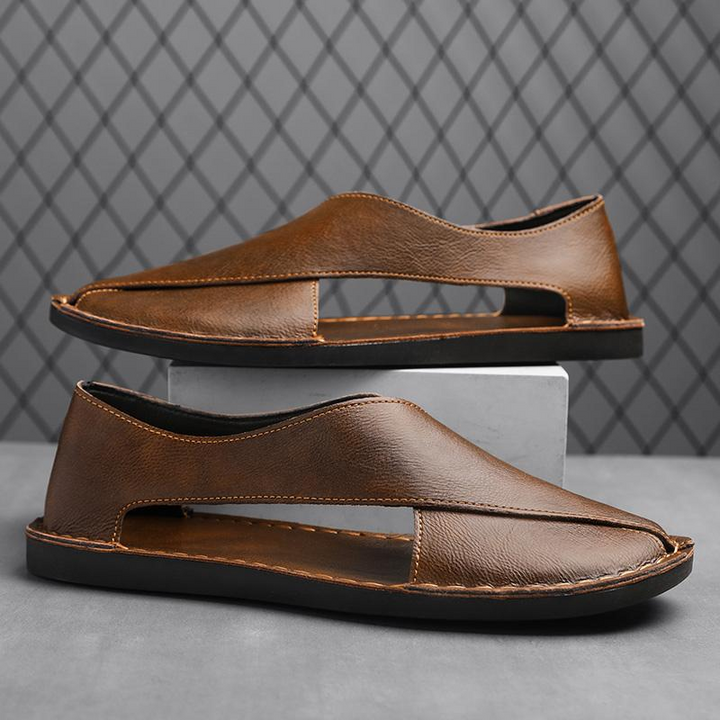 Brown leather open-toe slide sandal with V-cut strap and contrast stitching.