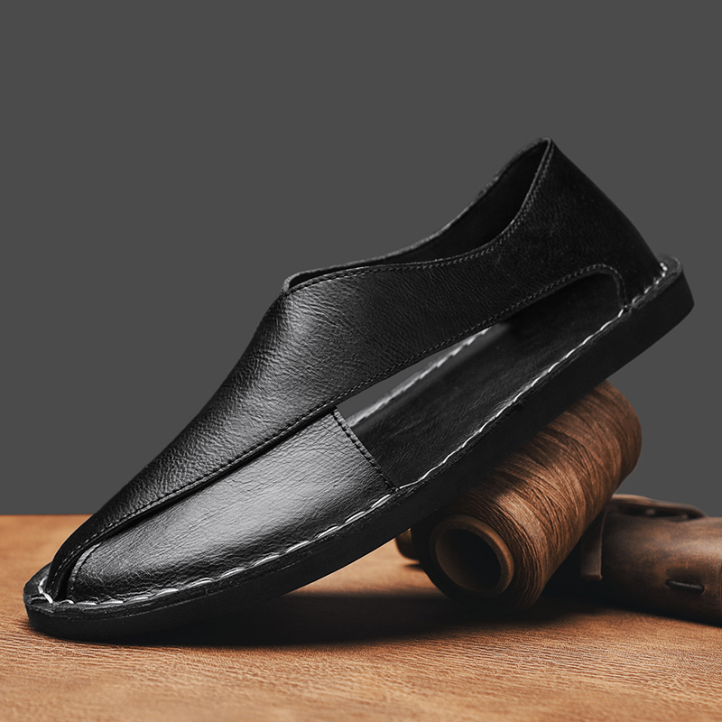 Black leather open-toe slide sandal with stitched V strap and dark rubber sole.
