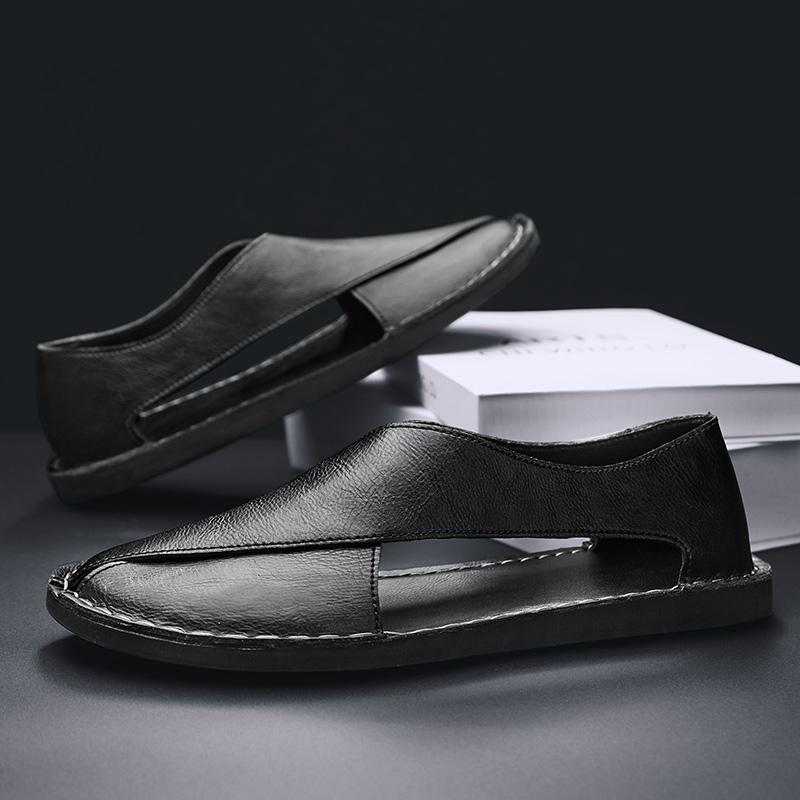 Black leather slide sandals with stitched strap and open-toe cutout