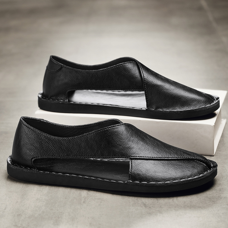 Black leather open-toe sandals on box, with stitched upper and low sole