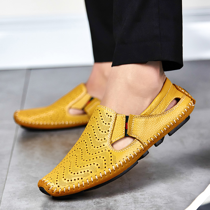Yellow perforated slip-on sandals with moc toe on concrete, contrast stitched sole