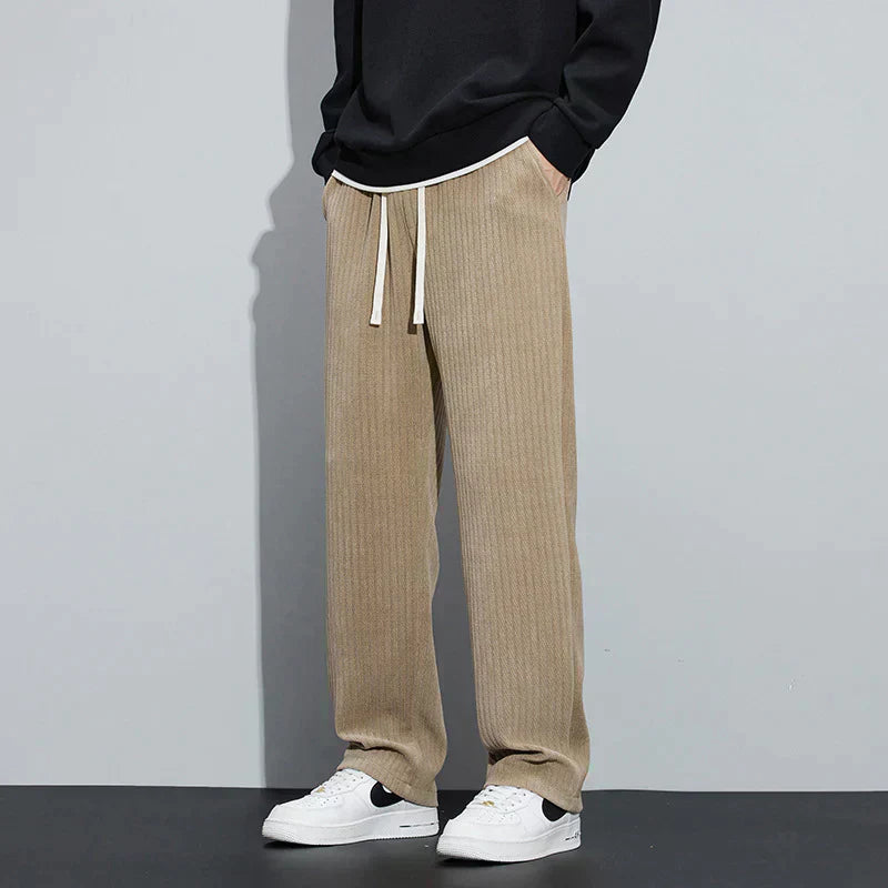 Nude Roman velvet pants with elastic waistband and drawstring ties, relaxed wide-leg style.