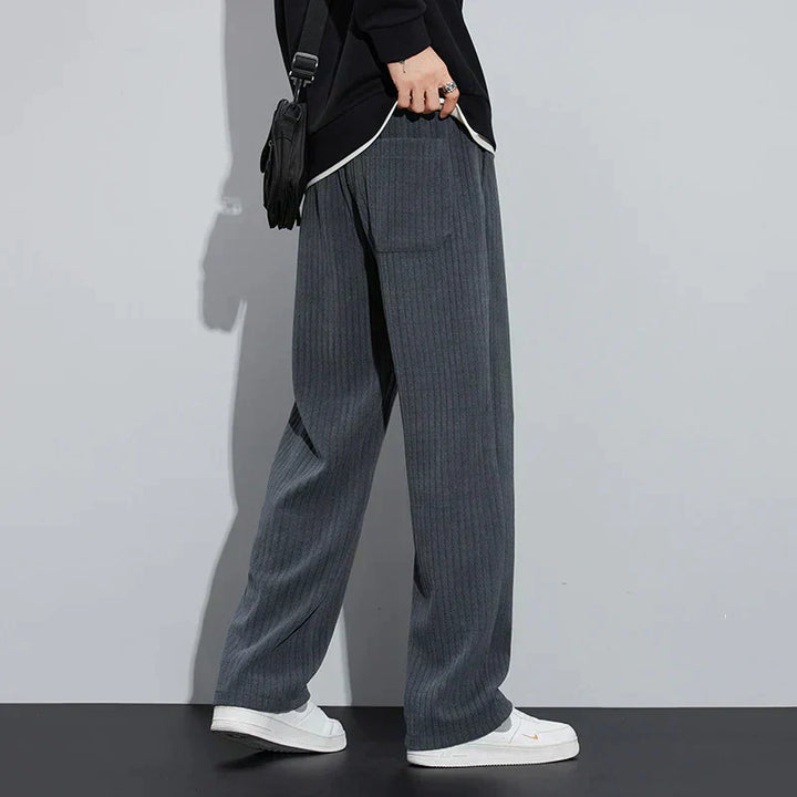 Blue-gray Roman velvet pants with elastic waistband and drawstring ties, wide-leg silhouette.