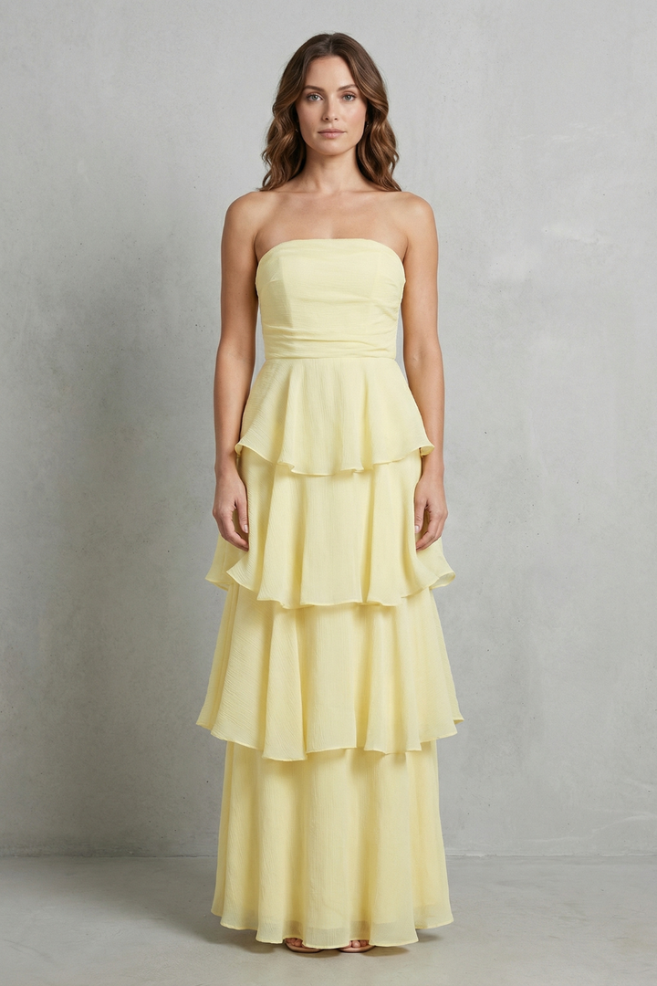 Light yellow strapless tiered maxi dress with peplum-style ruffle tiers