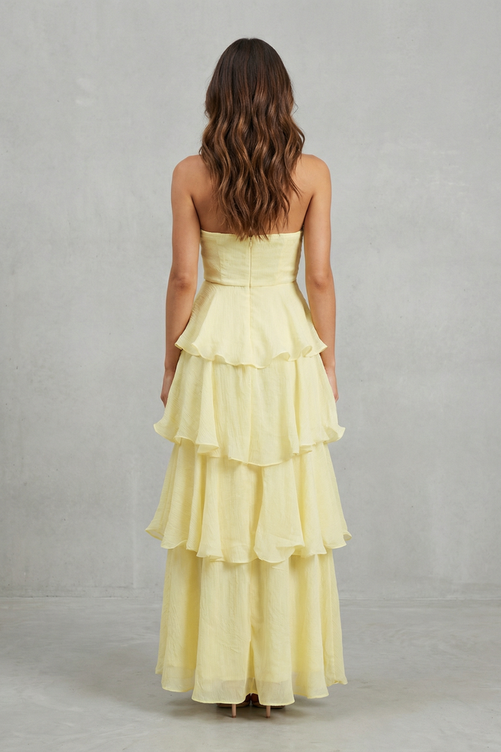 Back view light yellow strapless tiered maxi dress with layered ruffle skirt