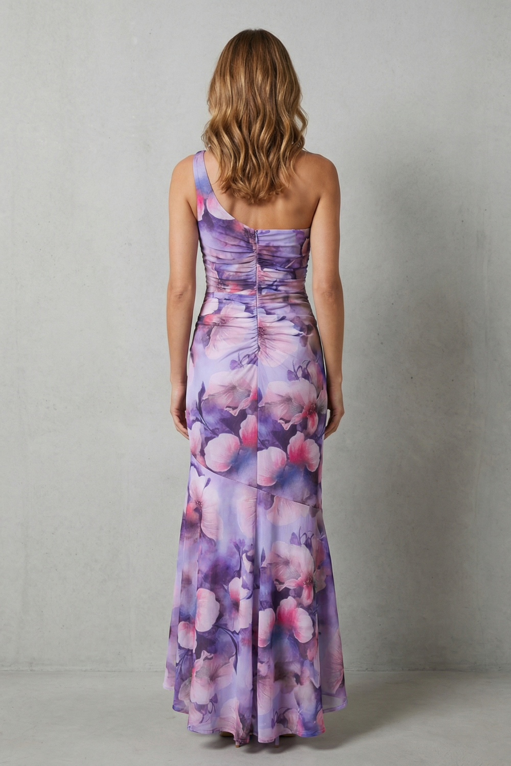 Back view: Purple floral one-shoulder maxi dress with ruched sides and layered hem